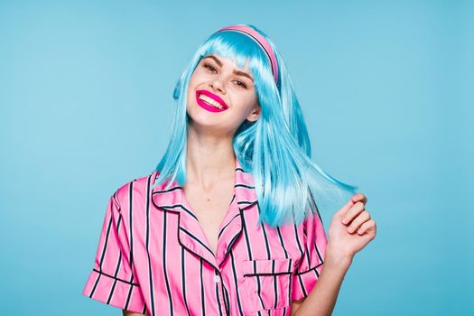 smiling woman purple hair red lips posing blue background. High quality photo