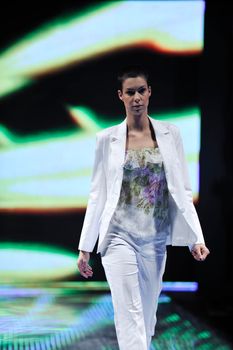 beautiful young fashion model woman walking on fashion show event 