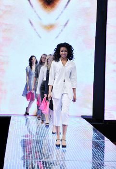 beautiful young fashion model woman walking on fashion show event 