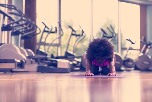 beautiful young african american woman exercise yoga in gym