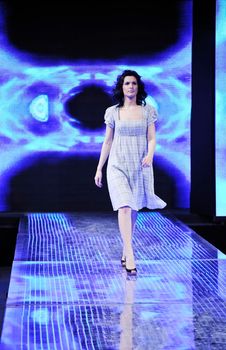 beautiful young fashion model woman walking on fashion show event 