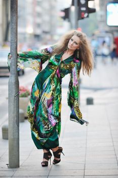 one beautiful young elegant woman in fashion and urban style dress in  city on  street at night alone