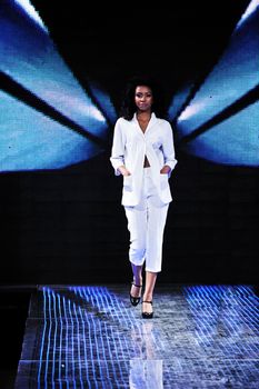 beautiful young fashion model woman walking on fashion show event 