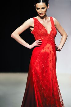 fashion show event and beautiful young woman at piste walking in luxury dress