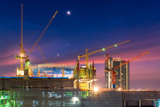 Construction site busy operate in beginning of building new complex infrastructure project at twilight time.