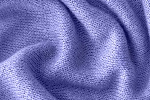 Color of the year 2022 soft knitted sweater texture closeup. Light violet blue abstract background. Trendy soft blue backdrop for web design. Luxury twisted fabric backplate