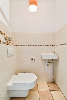 Lovely restroom with small sink and tiled floor