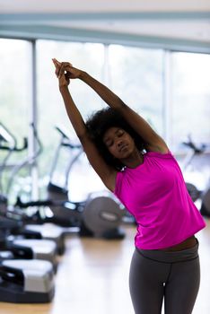 beautiful young african american woman exercise yoga in gym