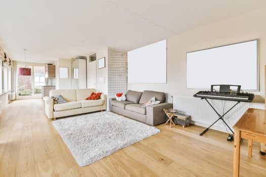 Lovely living room with milky and gray sofas and shaggy carpet