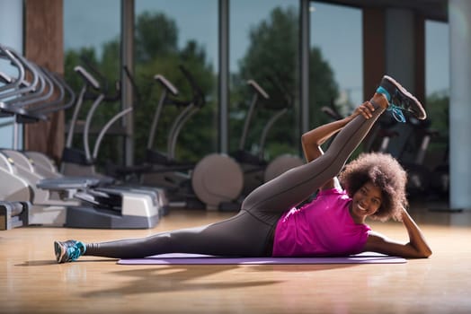 beautiful young african american woman exercise yoga in gym