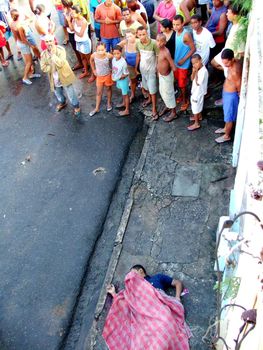 salvador, bahia, brazil - may 25, 2005: Black man is murdered in the street of the city of Salvador.