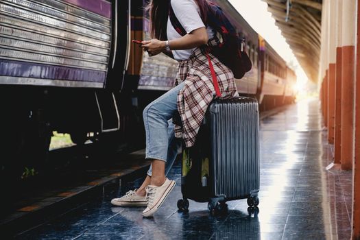 Alone traveler tourist with luggage at train station. work and travel lifestyle concept