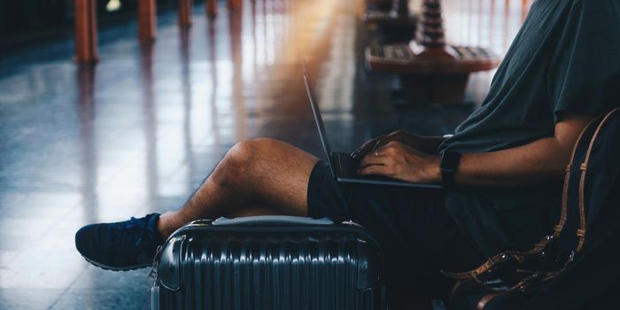 Image of Young freelance working at train station before travel. work and travel concept.