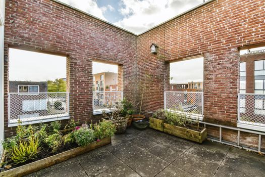 Adorable balcony with flowers in pots in a chic home