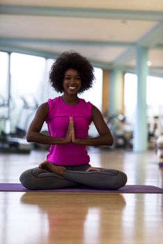 beautiful young african american woman exercise yoga in gym