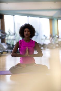 beautiful young african american woman exercise yoga in gym