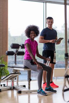 healthy couple have break  at  crossfit gym african  american woman with afro hairstyle