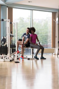 healthy couple have break  at  crossfit gym african  american woman with afro hairstyle