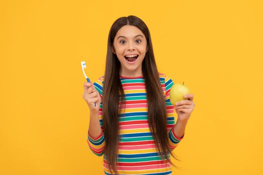 Surprising benefits of oral hygiene. Surprised girl hold tooth brush and apple. Tooth care. Dental health. Keep teeth healthy.