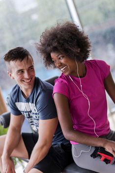 healthy couple have break  at  crossfit gym african  american woman with afro hairstyle