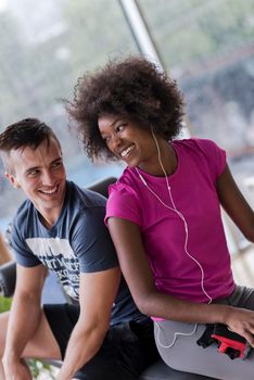 healthy couple have break  at  crossfit gym african  american woman with afro hairstyle