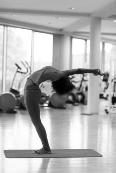 beautiful young african american woman exercise yoga in gym