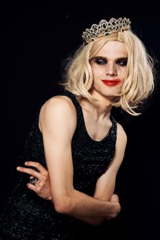 man in women's dress wig makeup posing bisexual. High quality photo