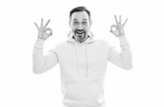 handsome mature man with beard and moustache in hoody isolated on white show ok gesture, perfection.