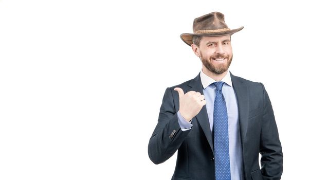 Happy businessman man in cowboy hat and suit point finger advertising gesture isolated on white copy space, advertise.