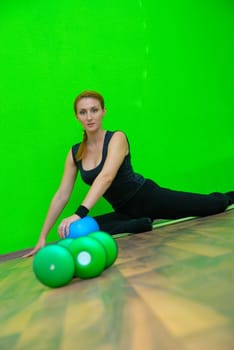 Girl in fitness studio doing yoga.