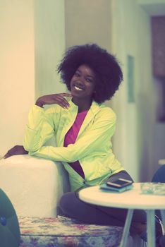 portrait of cute african american woman with afro hairstyle while  posing against old retro wooden background