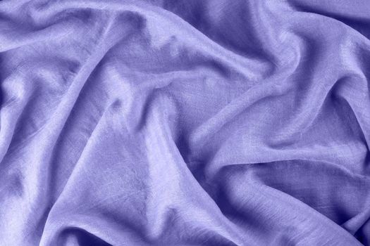 Close-up of lavender purple draped light fabric as background. Color of year 2022. Selective focus.