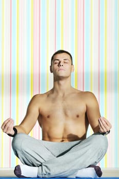 young man exercise and practice yoga fitness  in lotus position indoor in fitness club