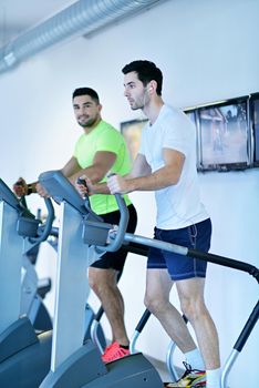 group of young people running on treadmills in modern sport  gym