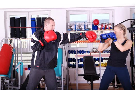 .woman and man box fighting