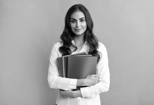 Happy girl student hold school books grey background, education.