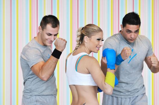 group of young adults exercise in fitness club with trainer