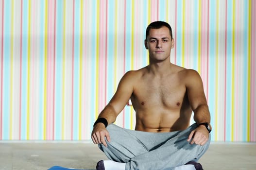 young man exercise and practice yoga fitness  in lotus position indoor