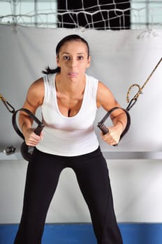 young woman practicing fitness and working out in a gym