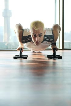 young healthy man exercise fitness indoor in sport studio