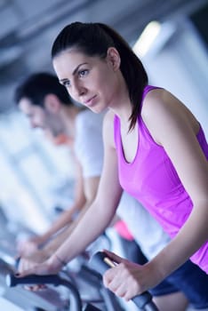 sport, fitness, lifestyle, technology and people concept - smiling woman exercising on treadmill in gym