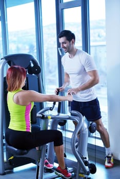 Gym woman exercising with her personal trainer