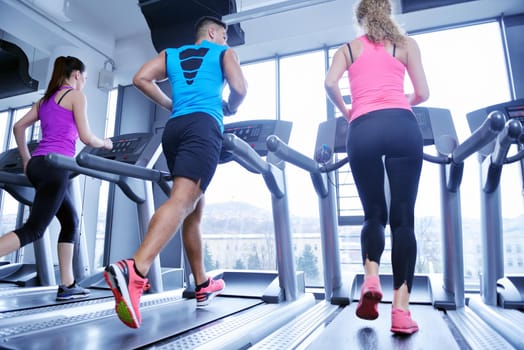 sport, fitness, lifestyle, technology and people concept - smiling woman exercising on treadmill in gym