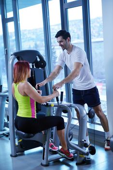 Gym woman exercising with her personal trainer