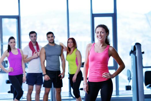 Group of people exercising at the gym and stretching