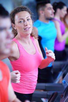 sport, fitness, lifestyle, technology and people concept - smiling woman exercising on treadmill in gym