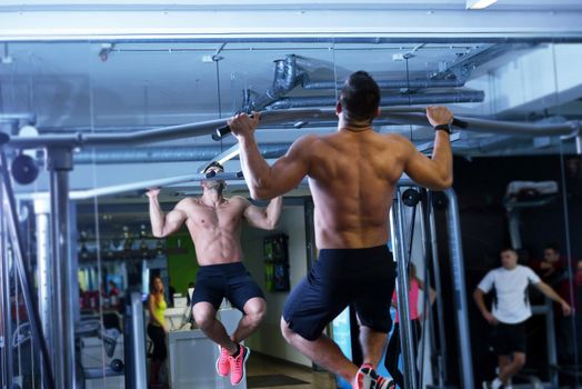 Strong handsome man exercising at the gym