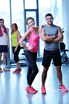 Group of people exercising at the gym and stretching