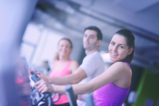 group of young people running on treadmills in modern sport  gym