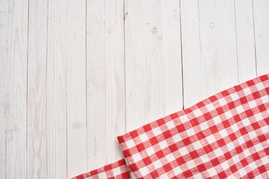 Red checkered tablecloth wooden background texture kitchen decoration. High quality photo